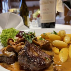 Grilled venison medallions with chanterelle mushrooms, potato dumplings and red wine