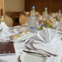 Festively set tables for family celebrations and corporate events in the restaurant of the Hotel Erber